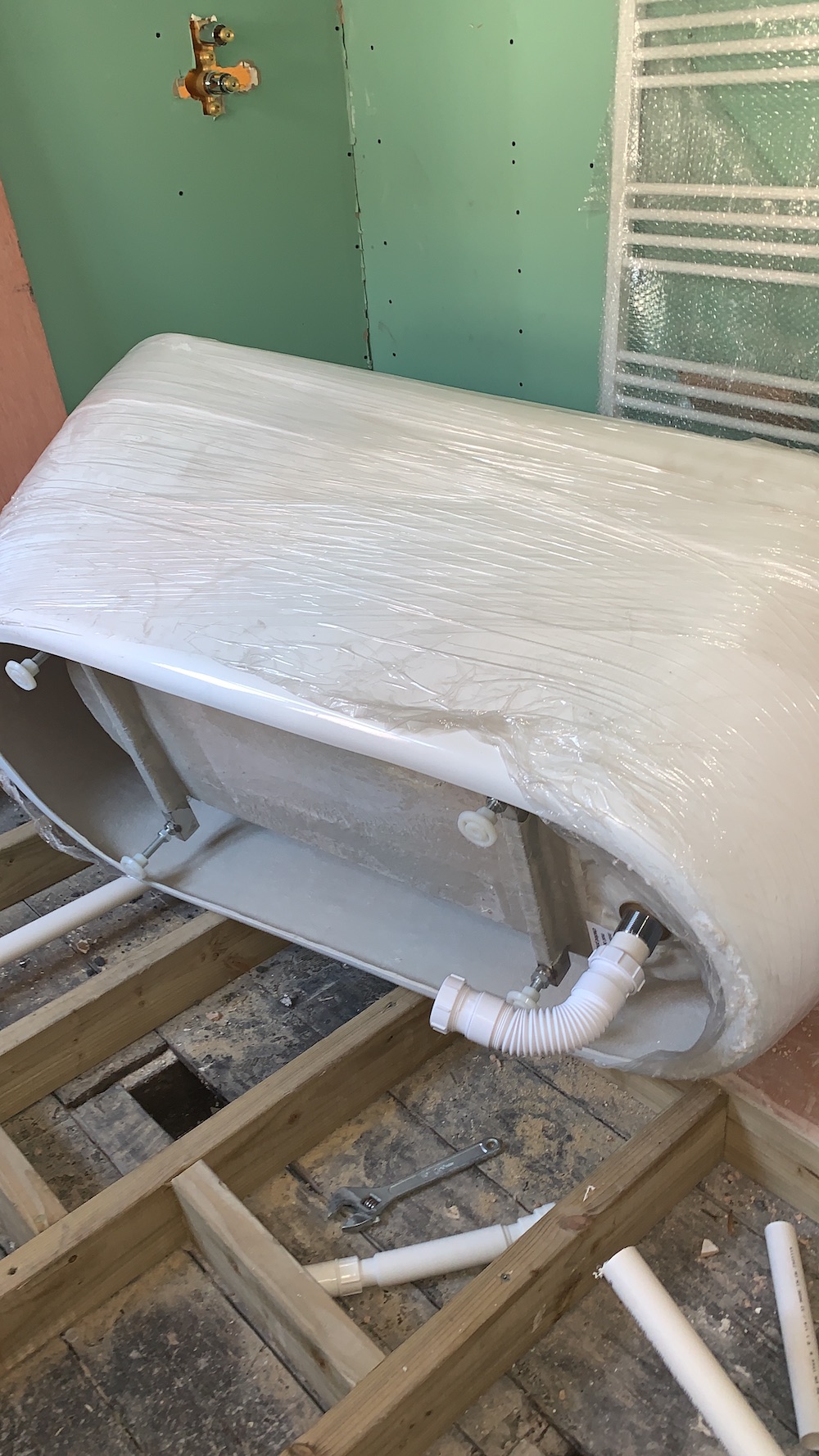 Building the raised floor structure and plumbing the bath outlet