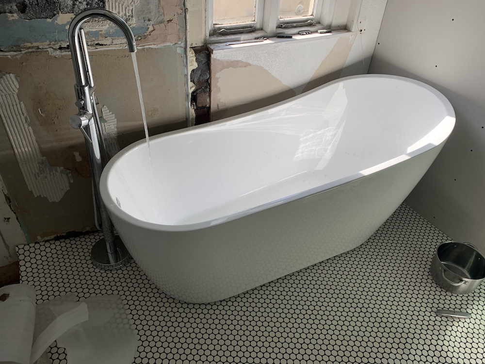 The installed bath with running taps