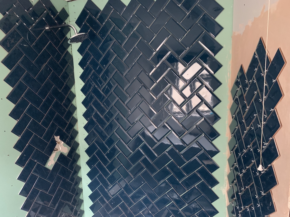 Continuing the tiling on all three shower-adjacent walls